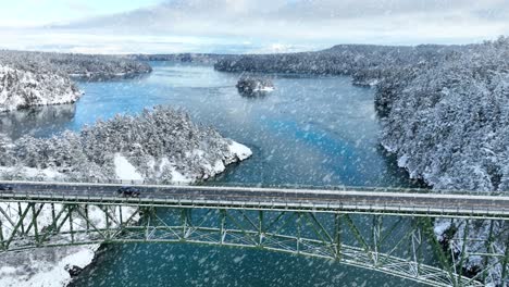 Aerial-view-of-cars-driving-across-Deception-Pass-in-the-snow