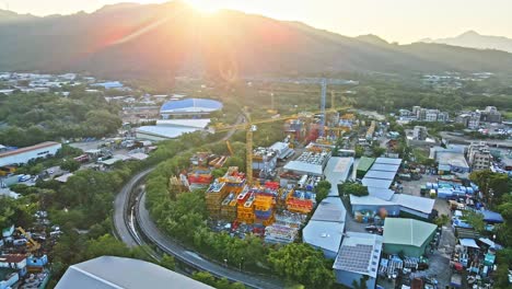 Yongmao-Machinery-tower-crane-Storage-Facility-in-Yuen-Long,-sunset-aerial-drone