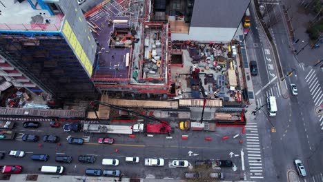 Aerial-view-in-front-a-building-site-in-Queens,-New-York-city---tilt,-drone-shot