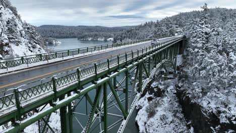 Rising-shot-of-a-lone-truck-driving-across-Deception-Pass-bridge-in-the-winter