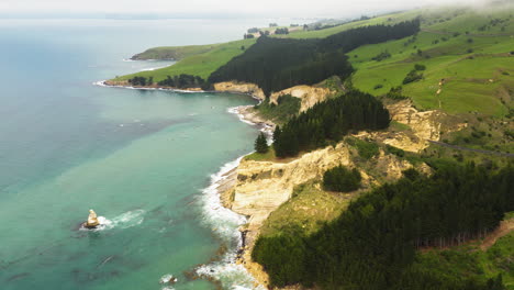 Rocky-coastline-near-blue-Pacific-ocean-in-New-Zealand,-aerial-drone-view