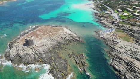 La-Pelosa-island,-tower-and-white-sandy-beach-in-Sardinia,-Italy---Aerial-4k-Reveal