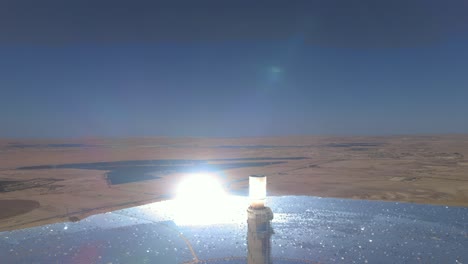 Tallest-solar-power-tower-in-the-world-close-up-view---the-mirrors-bend-the-light---aerial-drone-shot