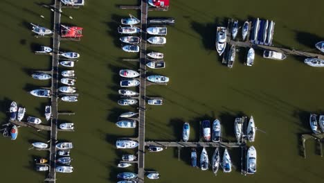 Top-down-birds-eye-view-aerial-shot-yachts-and-boats-docked-in-marina