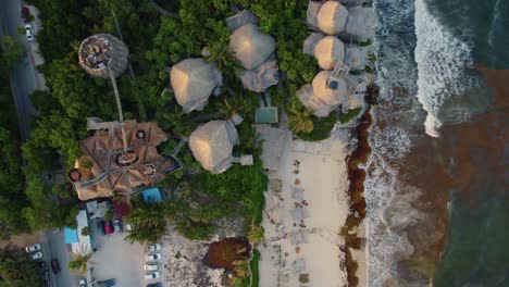 Aerial-Birds-Eye-View-Of-Eco-Chi-Treehouses-At-Azulik-Resort-With-Caribbean-Sea-Waves-Breaking-On-Beach