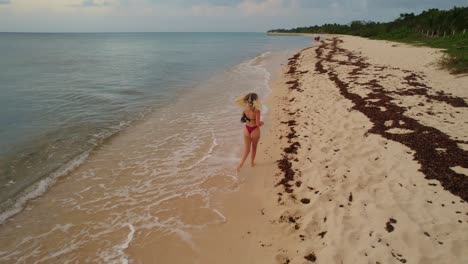 Carefree-Young-Female-Running-Along-Tropical-Beach-At-Cozumel