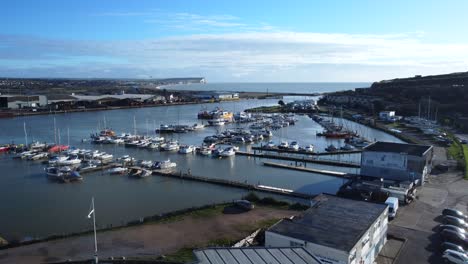 Long-and-slow-drone-shot-flying-over-marina-and-port-on-coast-of-UK