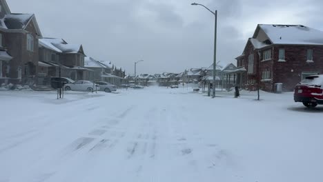 Residential-neighbourhood-with-mansions-covered-in-snow-during-cold-winter-storm