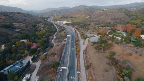 Drone-shot-of-a-main-roadway-through-the-winding-hills-of-Spain
