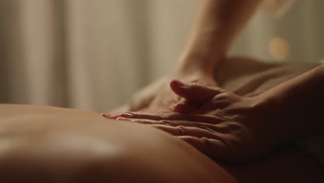 Professional-Back-Massage-Hands-in-dimly-lit-room