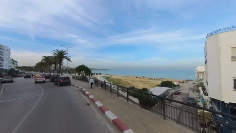 A-stunning-car-walk-along-the-La-Marsa-Corniche,-a-picturesque-coastal-road-located-just-outside-of-Tunis,-Tunisia