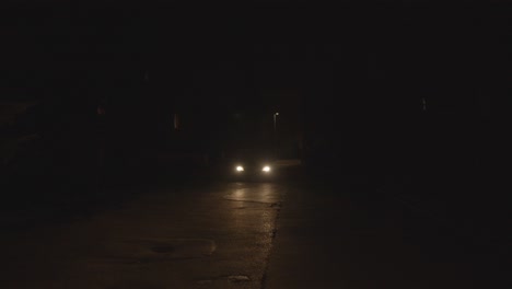 A-beautiful-shot-of-a-car-driving-through-a-dark-street