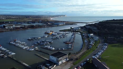 Wide-angle-aerial-shot-coastal-town-in-England-with-harbour-and-marina