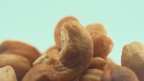 A-macro-close-up-shot-of-a-roasted-salty-cashew-bawl-on-a-rotating-stand,-slow-motion,-4k,-studio-lighting