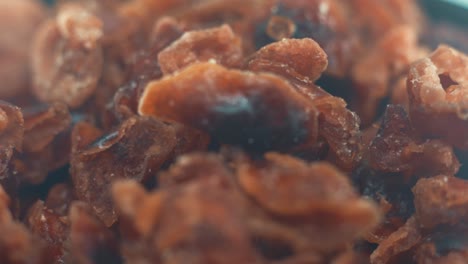 A-macro-close-up-shot-of-a-pile-of-dried-cranberries-in-a-bawl-on-a-rotating-stand,-slow-motion,-4k