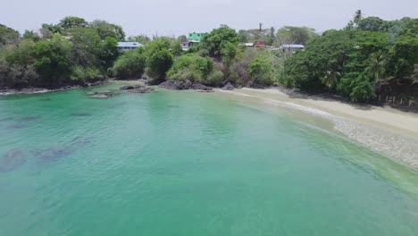 Low-flying-aerial-view-of-Black-rock-beach-on-the-island-of-Tobago-in-the-Caribbean
