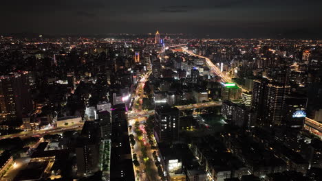 Aerial-hyperlapse-flight-over-city-of-Taipei-at-night-with-traffic---Glowing-digital-lines-in-different-colors-connecting-city-with-motion-graphic