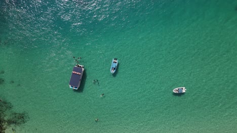 High-drone-view-of-a-protected-holiday-ocean-swimming-area-and-boat-harbor
