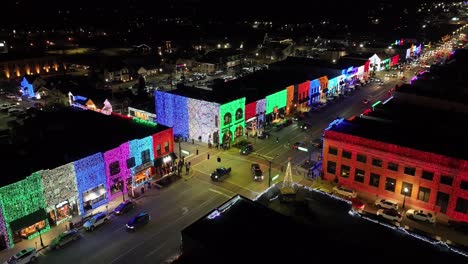 Rochester,-Michigan-skyline-at-night-lit-up-with-Christmas-lights-on-buildings-and-drone-video-stable