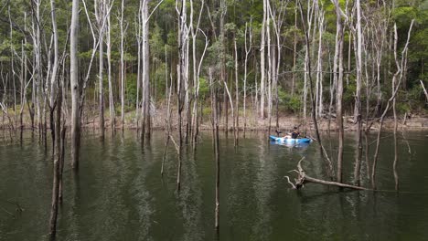 Female-in-a-kayak-paddling-through-a-flooded-forest