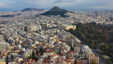 Aerial---General-cloudy-shot-of-Athens,-Greece-with-Mount-Lycabettus-in-the-background