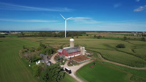 Above-a-farm,-a-wind-turbine-blows-in-the-wind-of-the-Wisconsin-countryside
