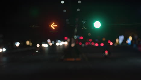 Stop-go-sigh-signal-traffic-lights-against-blurred-cityscape-moving-traffic