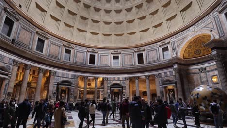 People-inside-the-Pantheon-in-Rome,-Italy-with-video-tilting-down-from-dome-to-people