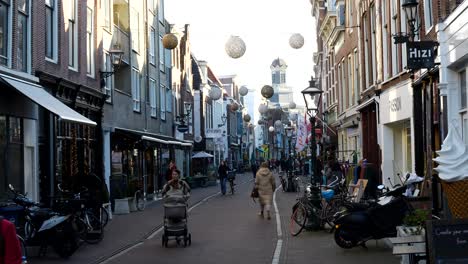 Slow-motion-shot-of-pedestrian-strolling-in-shopping-street-of-Leiden-during-sunny-day