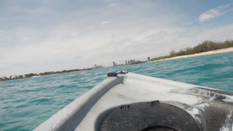 FPV-of-a-kayak-drifting-in-the-ocean-towards-a-city-skyline