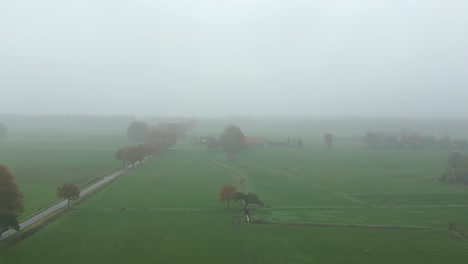 Aerial-footage-of-a-foggy-farmland-in-autumn-colors