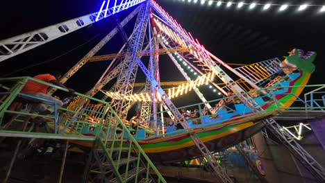 Pirate-Ship-swinging-night-side-view-in-festival