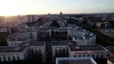 Beautiful-flyover-of-the-city-center-of-Montpellier,-France-while-a-stunning-sunset-during-golden-hour