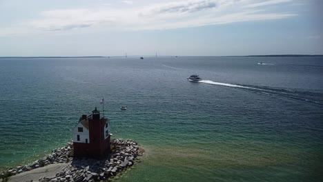 Round-Island-Lighthouse,-Ferry-and-Mackinac-Island-Aerial-Follow