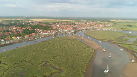 Establishing-Drone-Shot-of-Wells-Next-The-Sea-Coastal-Town-with-Salt-Marsh-and-Sailing-Boats-in-North-Norfolk-UK-East-Coast