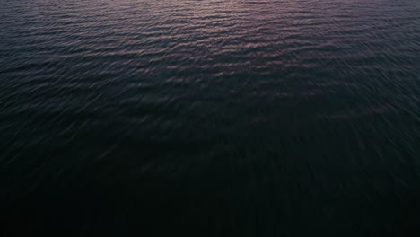 Fast-drone-flyover-of-ocean-water-at-sunset