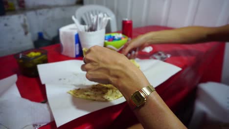Girl-eating-a-gozleme-with-her-hands