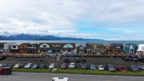 Aerial-drone-pan-down-coastal-main-street-shops-in-Homer-Alaska-halibut-fishing-town
