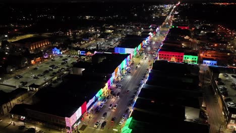 Rochester,-Michigan-skyline-at-night-lit-up-with-Christmas-lights-on-buildings-and-drone-video-circling