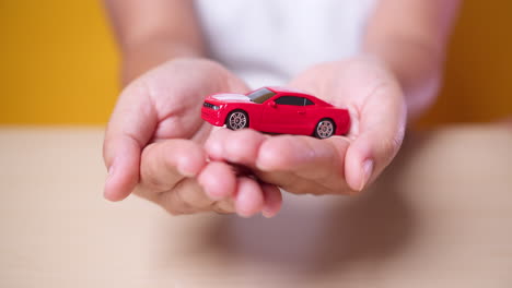 Woman-hand-with-holding-red-car-concept-for-insurance,-buying,-renting,-fuel-or-service-and-repair-costs