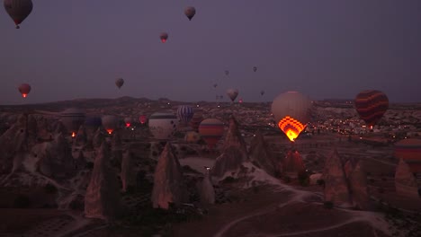 Sunrise-view-from-a-balloon-of-the-balloons-taking-off-in-Goreme,-Cappadocia