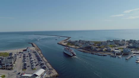Aerial-of-a-block-island-ferry-boat-leaving-a-harbor-in-rhode-island-with-passengers-during-the-summer-time