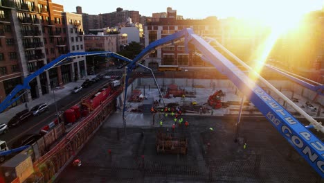 Aerial-view-around-concrete-pumps-pouring-cement-on-a-construction-floor-in-NY