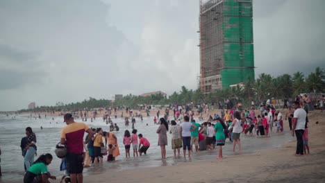 People-gathered-at-beach-in-the-evening-with-families-and-kids-playing