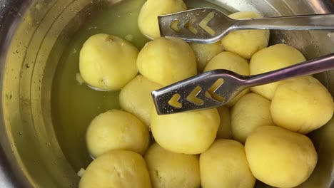 Close-up-shot-over-yellow-rajbhog-sponge-rasgulla-sweet-on-display-in-an-Indian-function