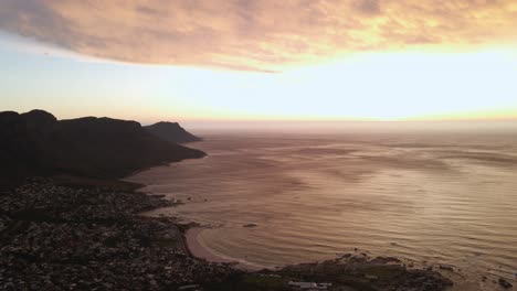 Girl-dancing-on-the-top-of-Lion's-head-in-Cape-Town-South-Africa-at-sunset---aerial-shot