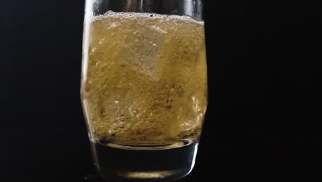 Close-up-slow-motion-of-soda-being-poured-in-ice
