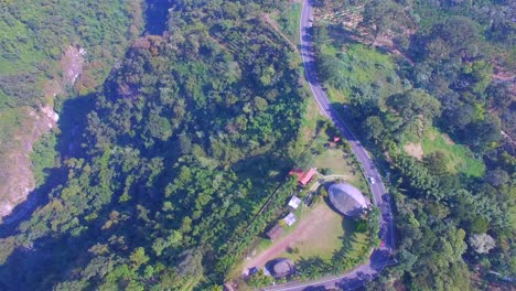 beautiful-aerial-view-with-drone-of-flying-over-glens-and-roads-in-the-jungle-of-Ixhuatlan-del-café,-Veracruz,-Mexico
