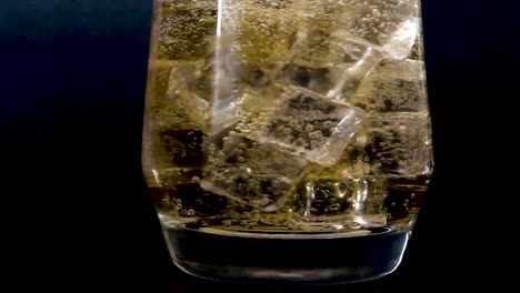 Slow-motion-of-ice-being-dropped-into-a-glass