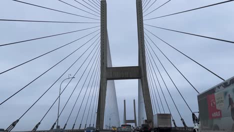 Moving-through-the-bottom-of-the-Alex-Fraser-Bridge-Delta-in-Vancouver-Canada-on-a-overcast-cloudy-day-British-Columbia